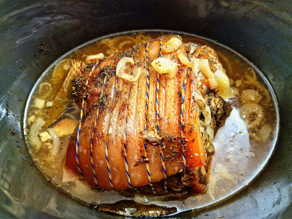 cooked pork shoulder in a slow cooker