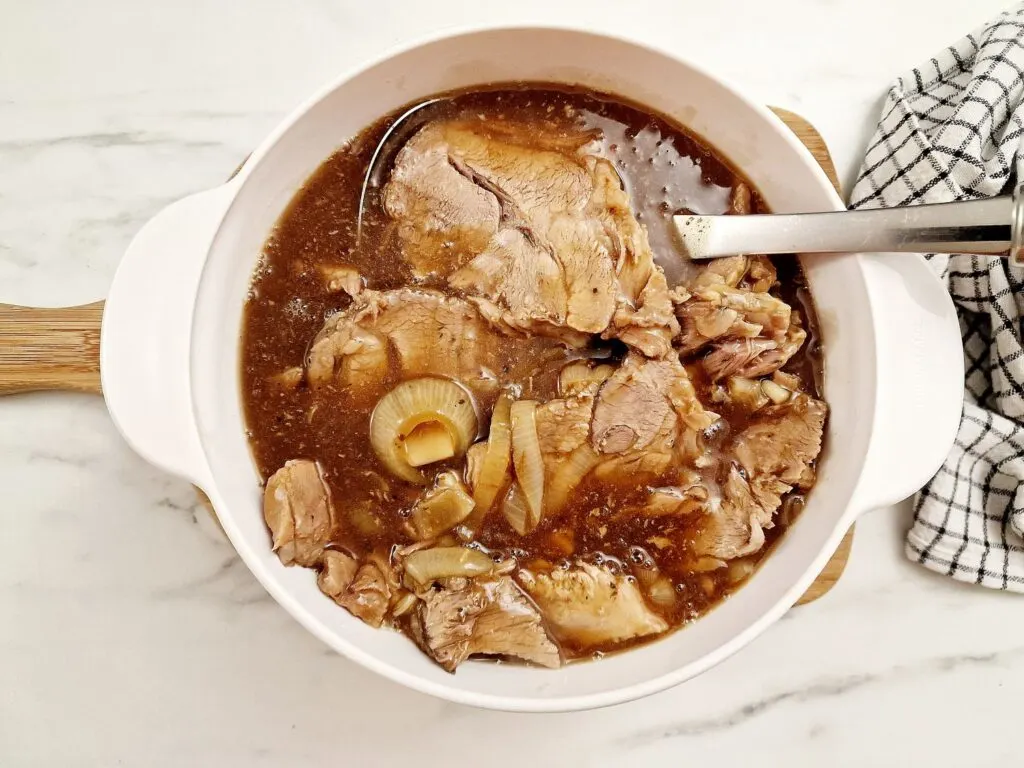 pork shoulder with gravy and onions