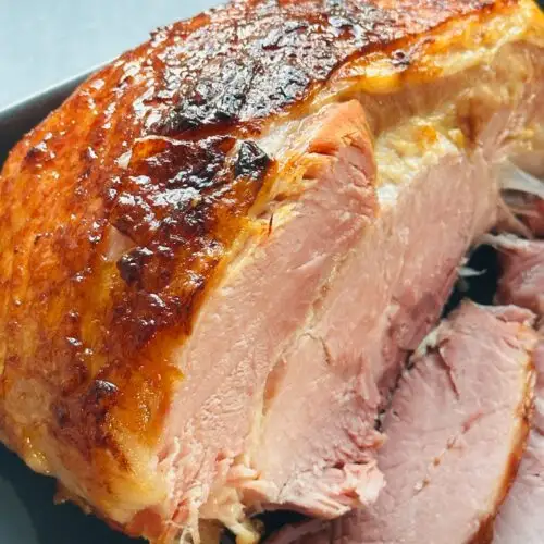 sliced gammon in a serving dish that has been cooked in a pressure cooker