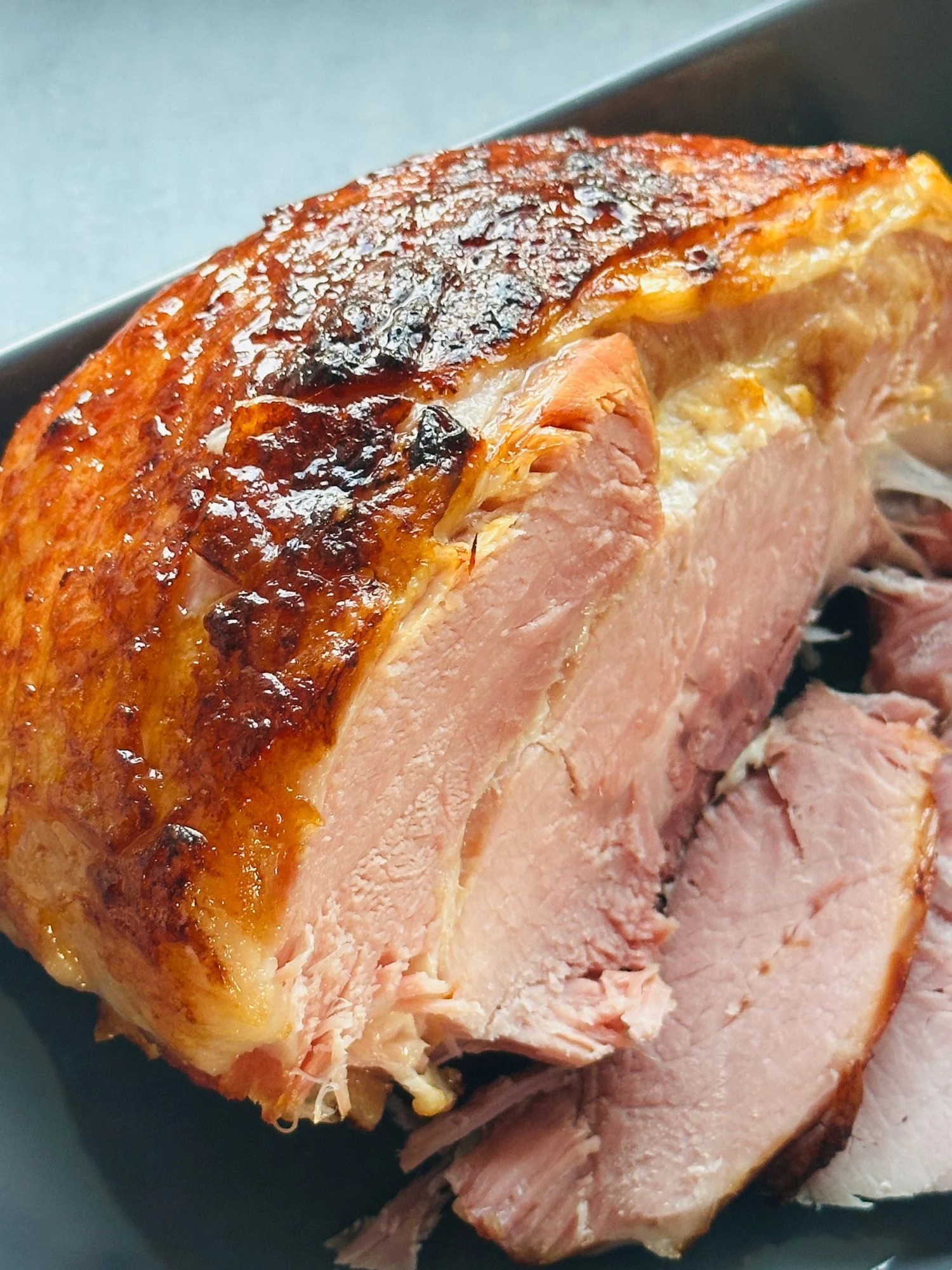 sliced gammon in a serving dish that has been cooked in a pressure cooker