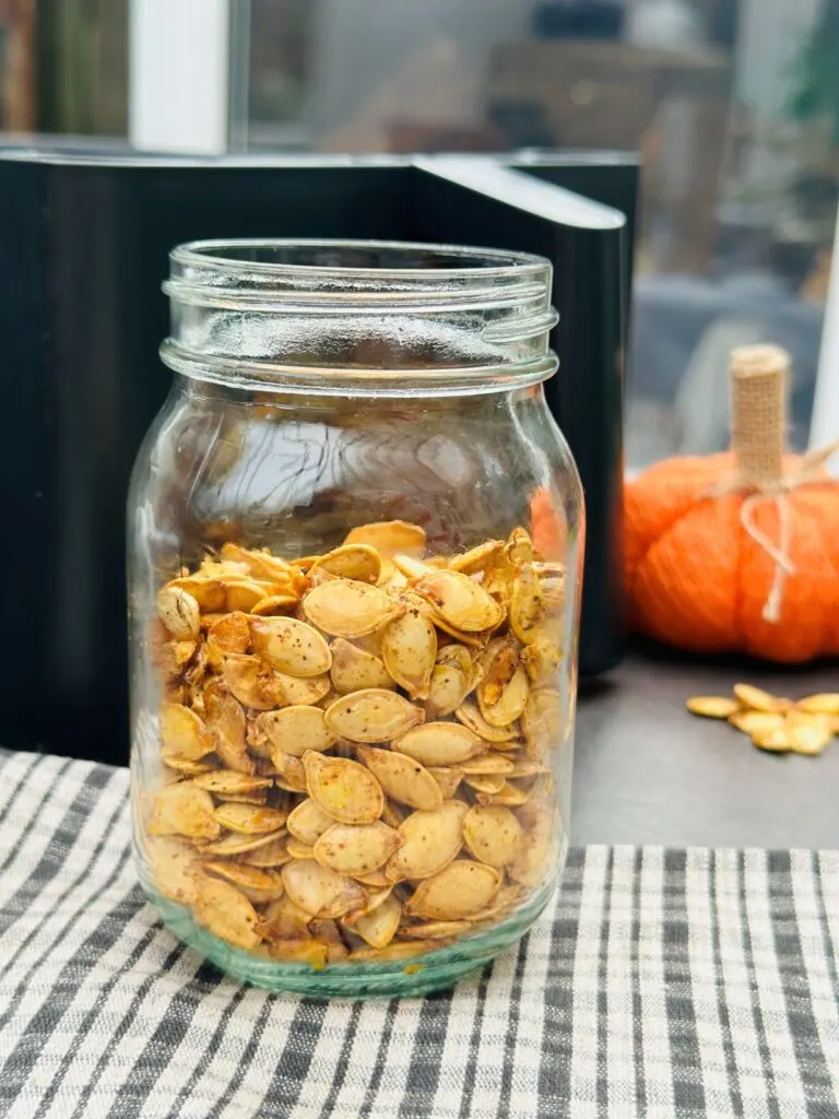 pumpkin seeds in jar next to air fryer