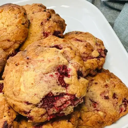 baked raspberry and white chocolate cookies on a plate