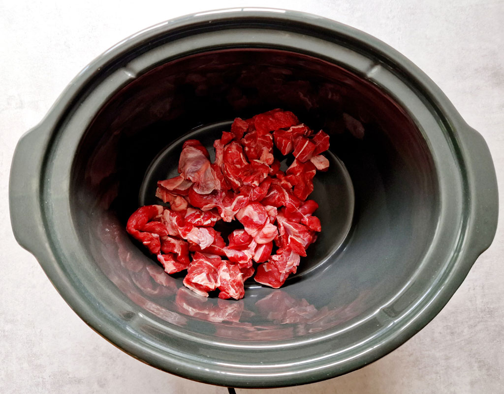 diced raw beef in slow cooker