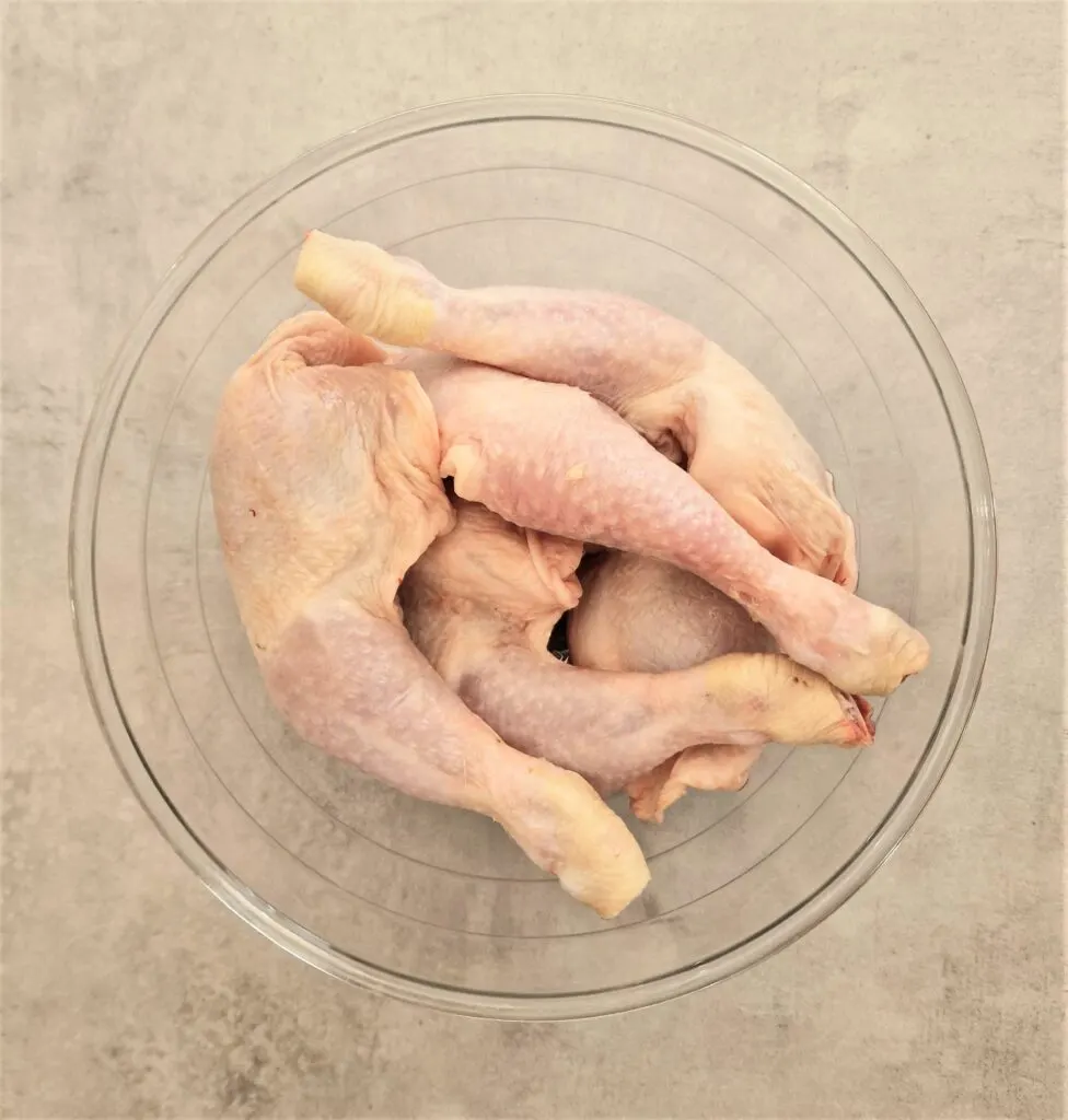 raw chicken legs in a bowl