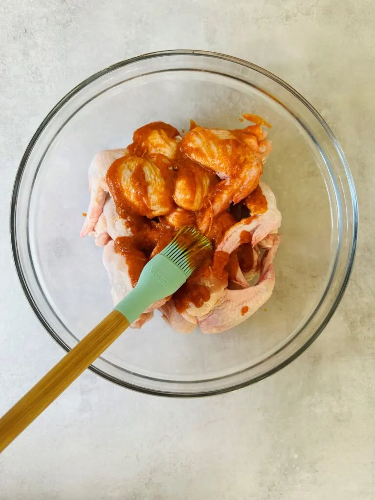 raw chicken wings in hot sauce