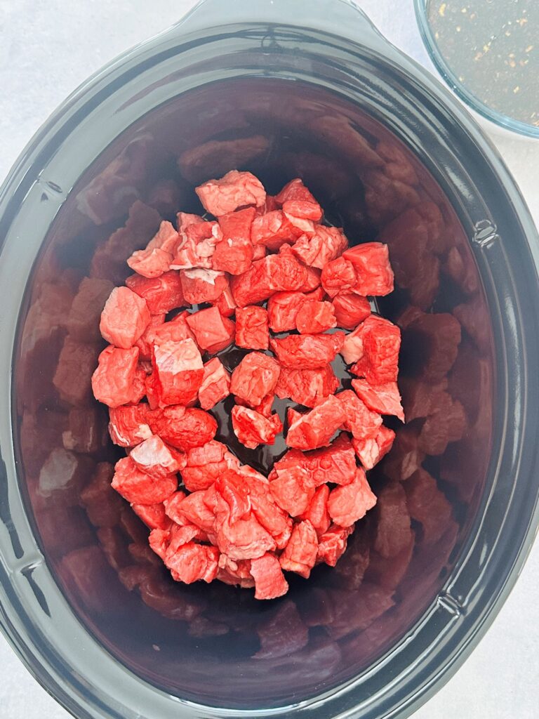 raw diced beef in slow cooker