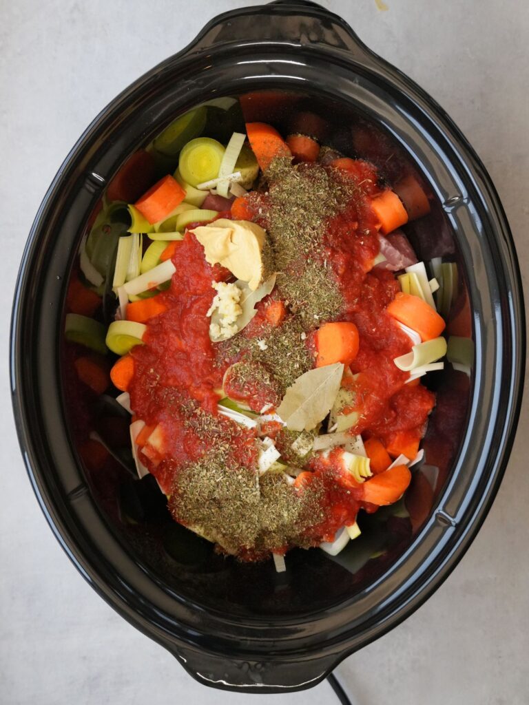 slow cooker filled with raw ingredients for cooking a slow cooker