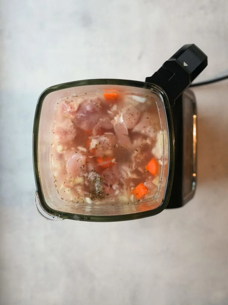 raw ingredients added to ninja soup maker: raw chicken, carrot, potatoes, herbs and stock
