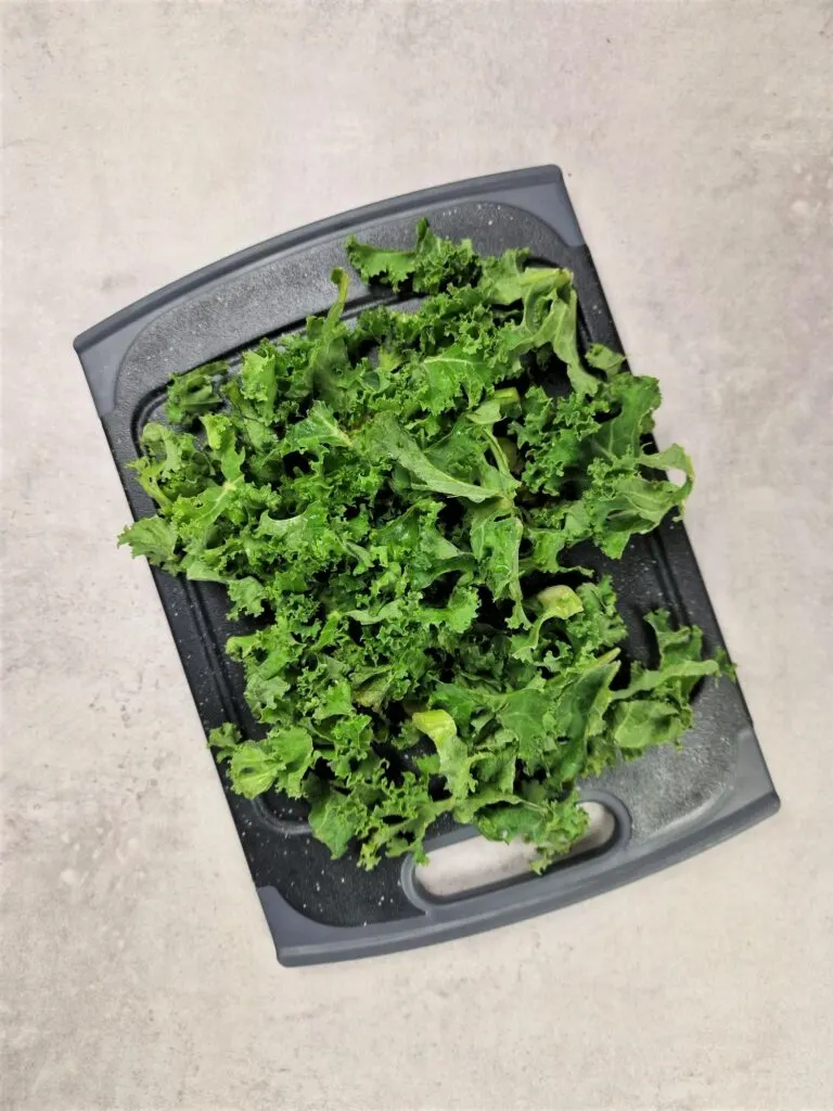 fresh kale shredded on a chopping board