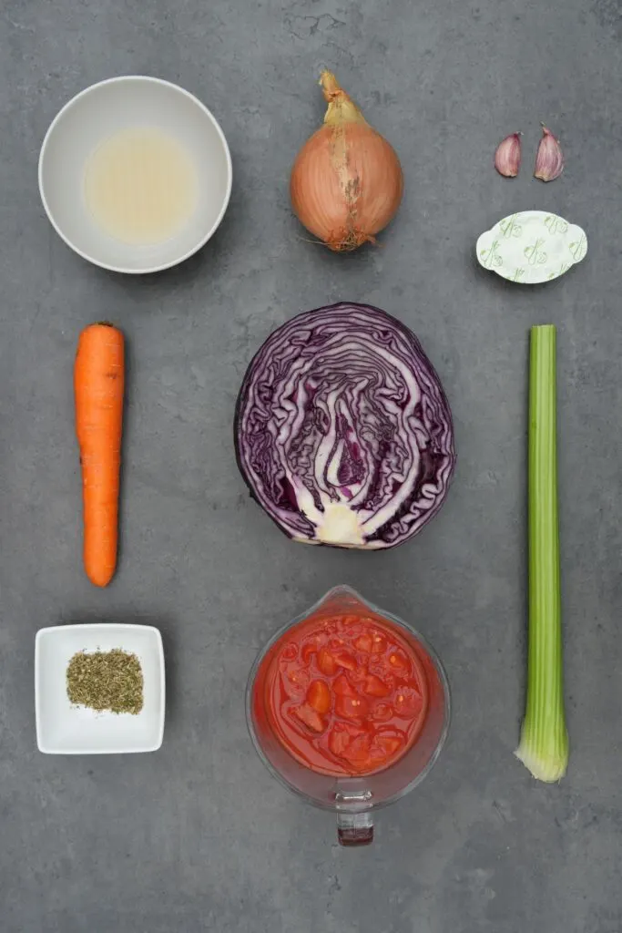 red cabbage soup ingredients for soup maker - half a red cabbage, 1 carrot, 1 celery stalk, 1 onion, 2 cloves garlic, 1 vegetable stock pot, 2 tbsp apple cider vinegar, 1 tsp dried mixed herbs