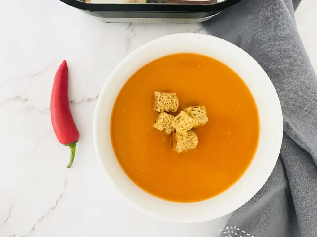 red pepper chilli soup next to a ninja soup maker