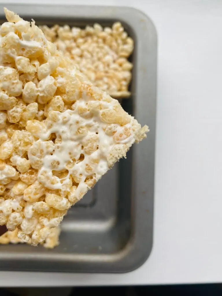 Rice Krispie Marshmallow Treats Rice Krispie Marshmallow Treats in baking tray with one cut out and held up