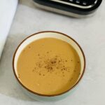 roasted parsnip and garlic soup next to a Ninja soup maker