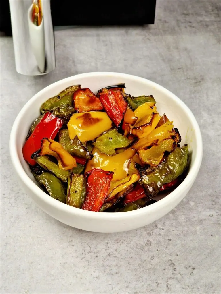 roasted peppers next to an air fryer