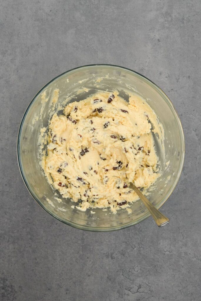 rock cake mixture in a glass bowl with a wooden spoon 