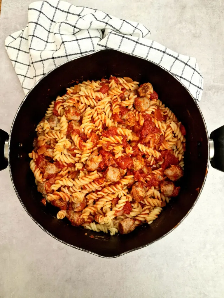 sausages and pasta in saucepan