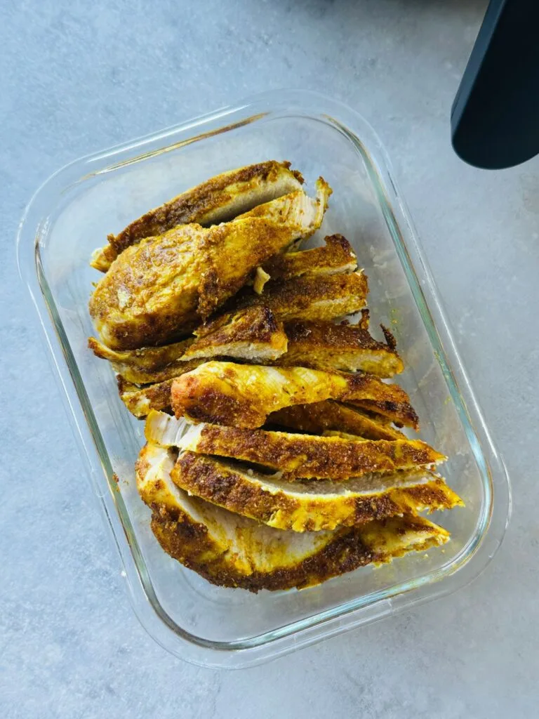 air fried chicken breast sliced and put in glass container to be stored for later