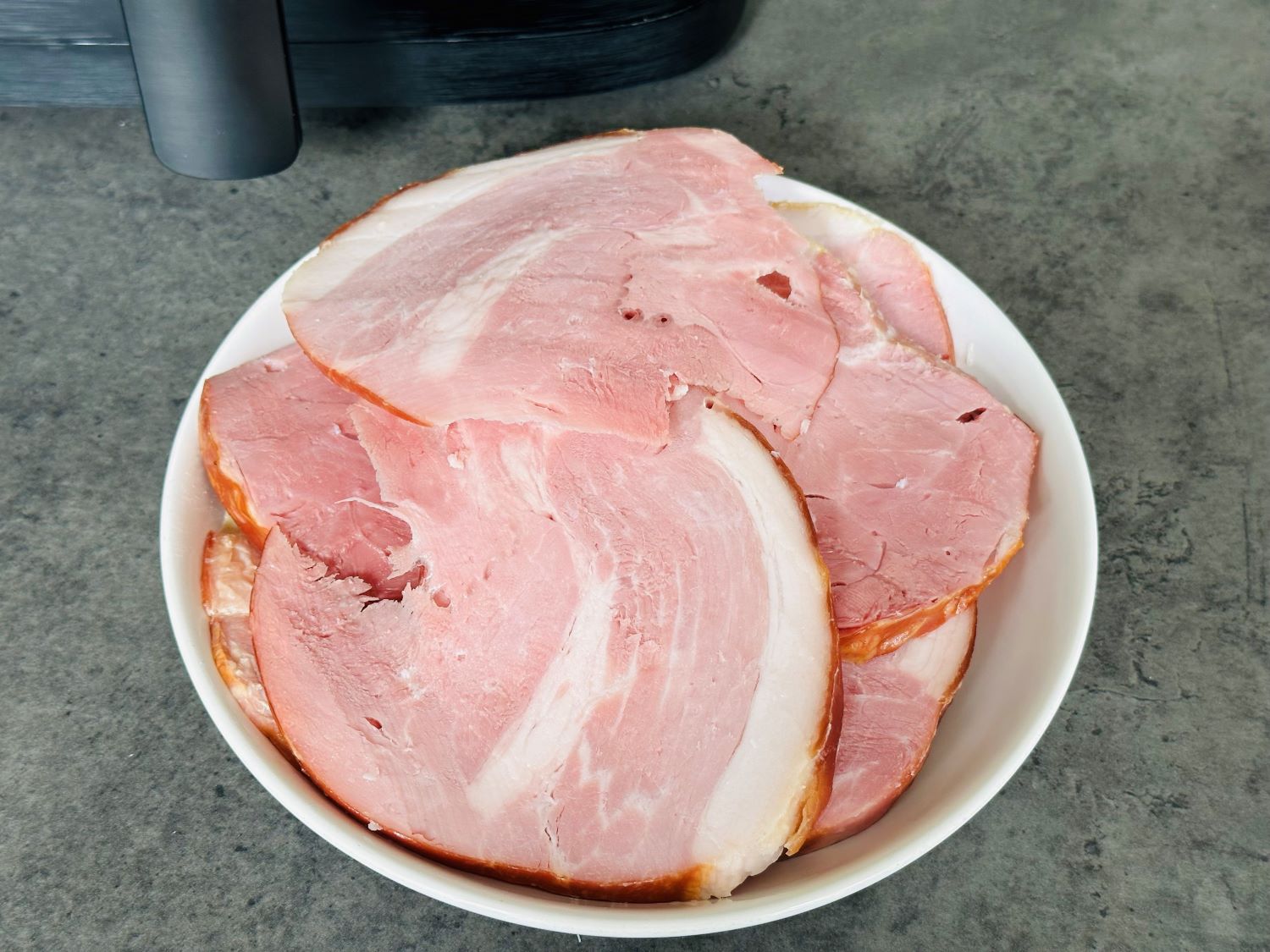 sliced gammon joint next to air fryer