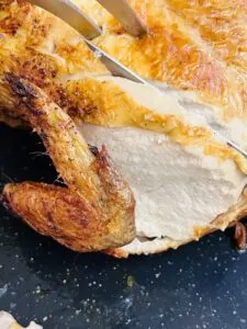 slicing rotisserie whole chicken