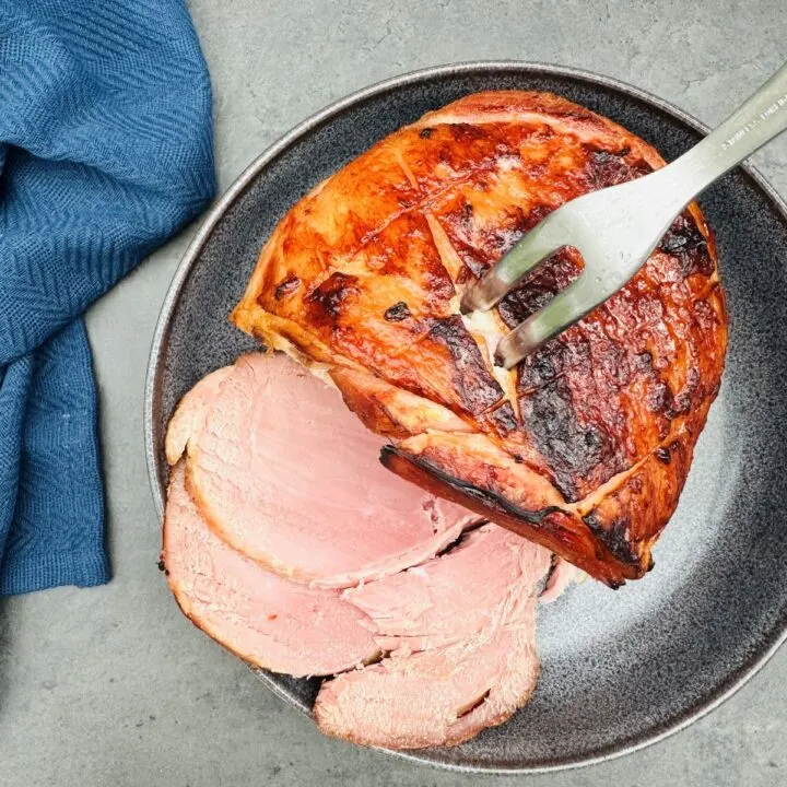 slow cooked gammon sliced on a plate