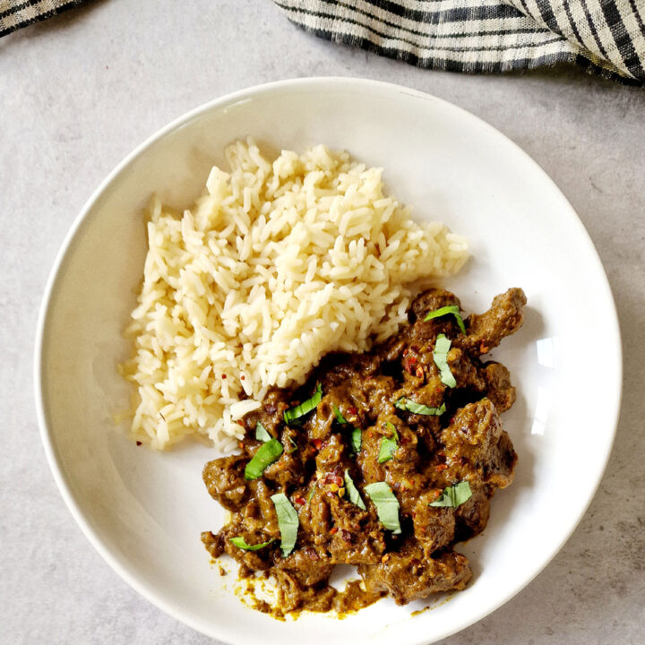 slow cooker beef rendang in a bowl with rice