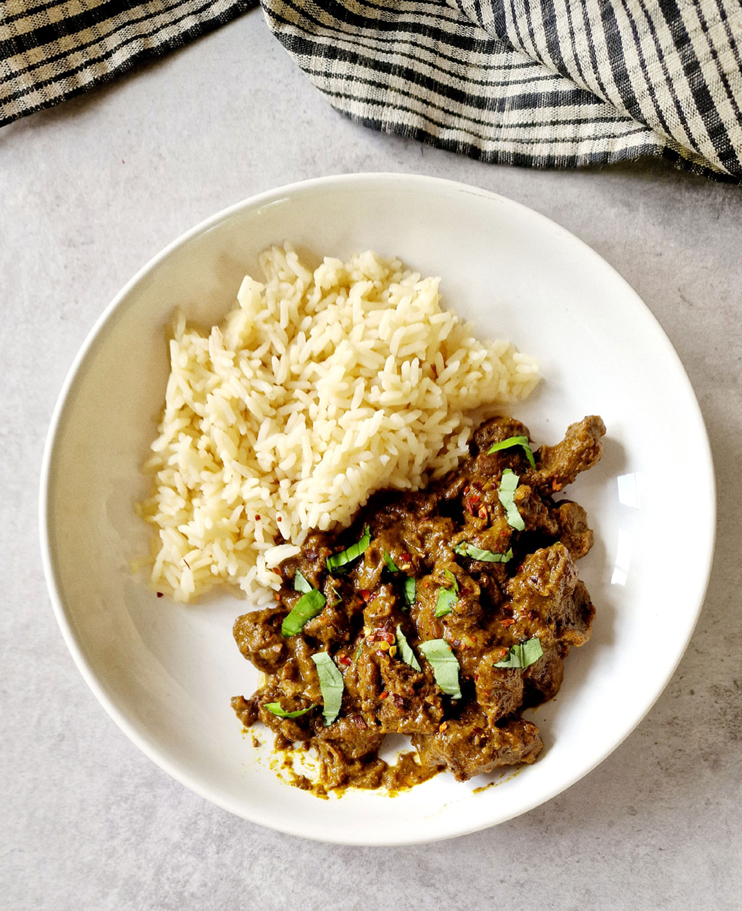 slow cooker beef rendang in a bowl with rice