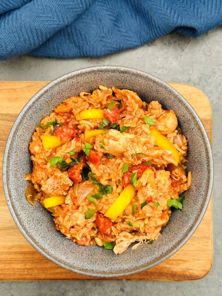 slow cooker chicken and chorizo with a rice in a serving bowl