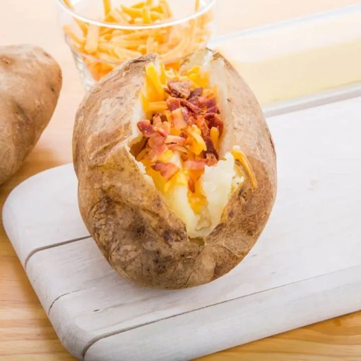 slow cooker jacket potatoes with cheese and bacon topping