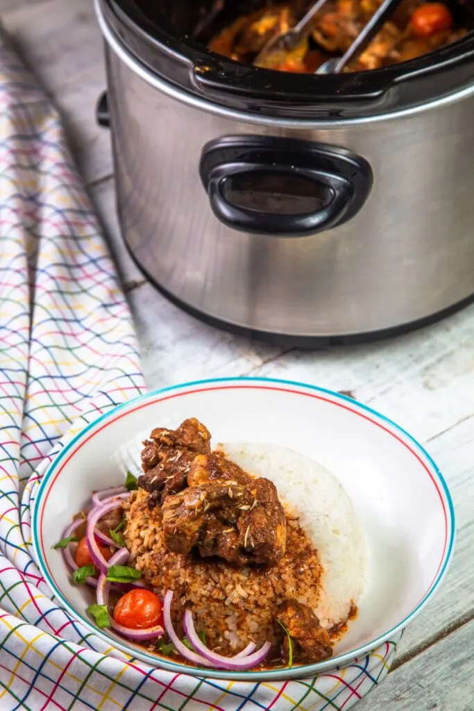 lamb curry with rice next to slow cooker