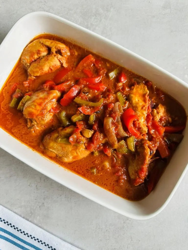 peri peri chicken cooked in a slow cooker served in a white bowl