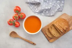 fresh tomato soup from soup maker with fresh bread and tomatoes