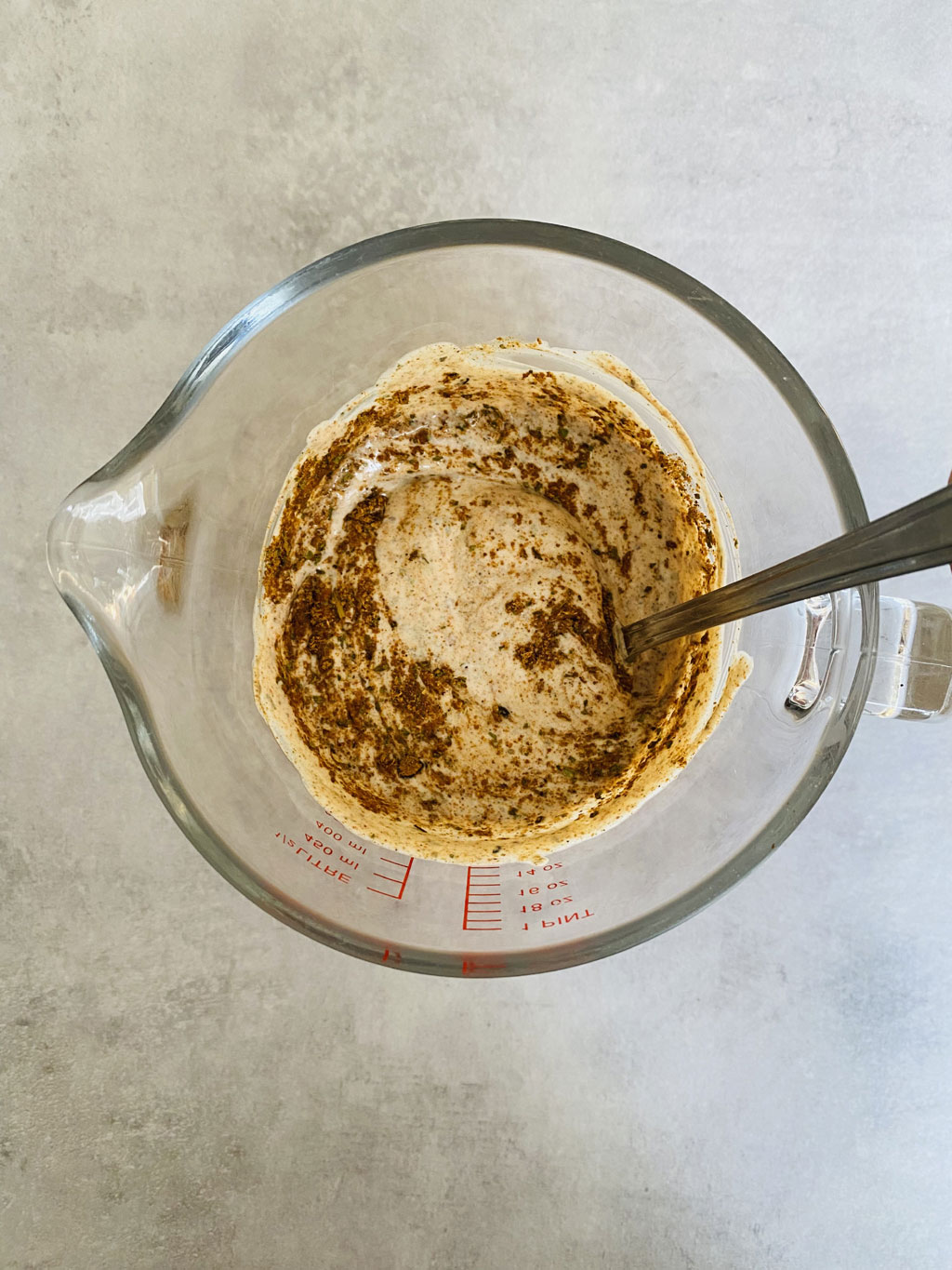 mixing tikka powder in yoghurt for marinade