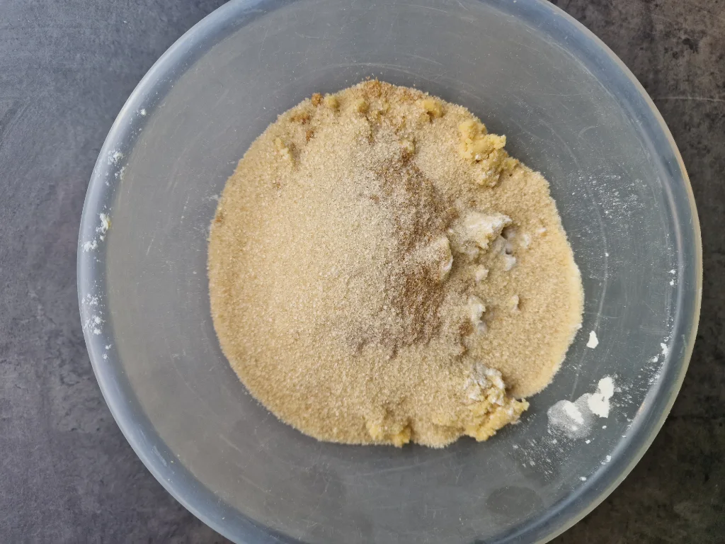 Mixing sugar into breadcrumbs