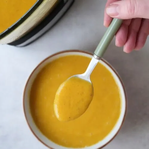 sweet potato and chickpea soup maker soup in a bowl with a spoon above it