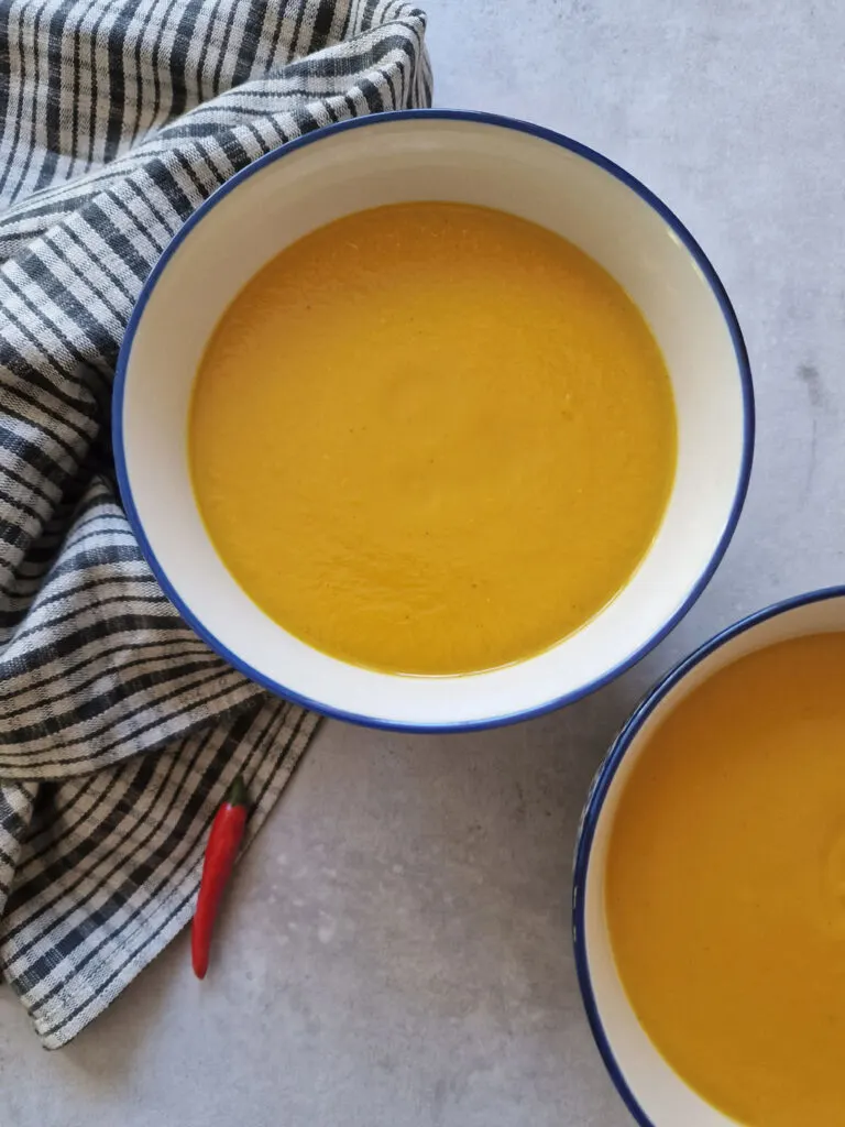 sweet potato and red chilli soup next to a red chilli