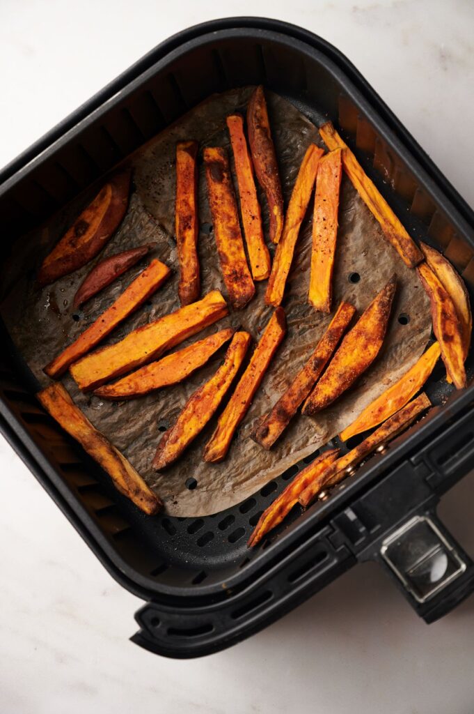 sweet potato fries in air fryer basket cooked