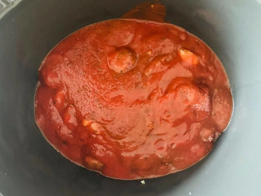 tomato sauce over meatballs in slow cooker