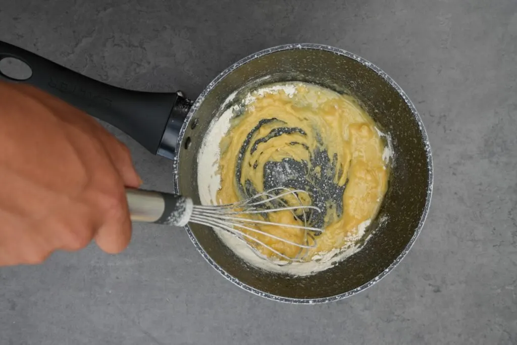 whisking butter into flour for lasagne white sauce