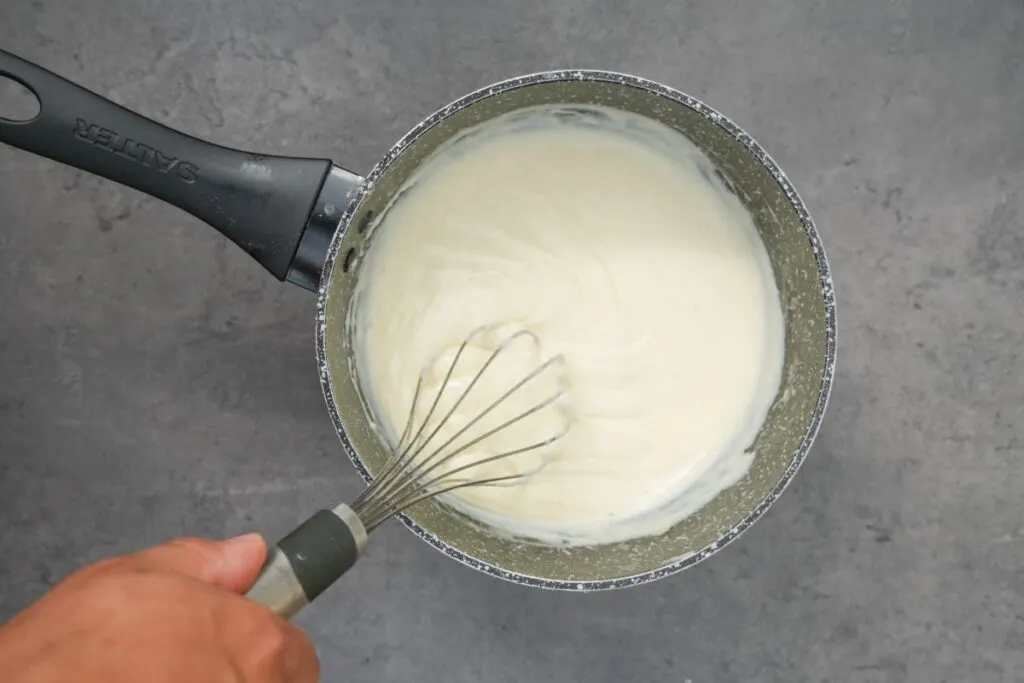 lines forming in white sauce for lasagne