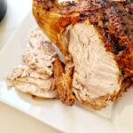 whole chicken carved next to air fryer