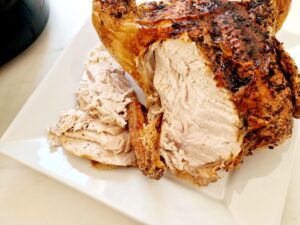 whole chicken carved next to air fryer