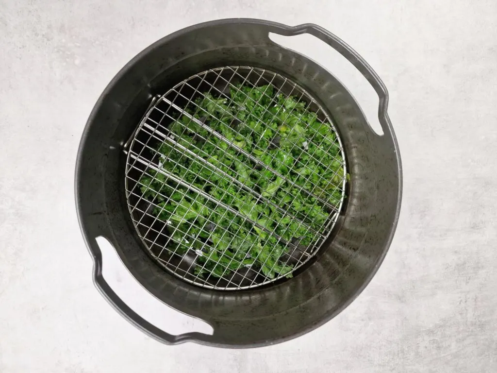 lay metal trivet over kale in air fryer basket to stop it flying about